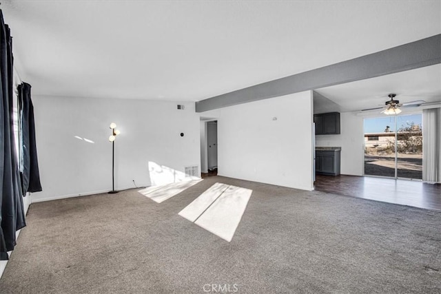 spare room featuring dark carpet and ceiling fan