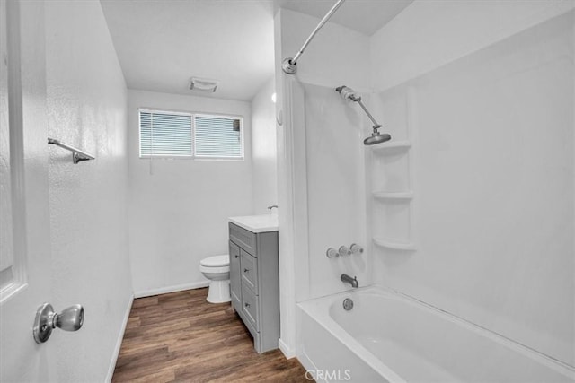 full bathroom with hardwood / wood-style floors, vanity, toilet, and tub / shower combination