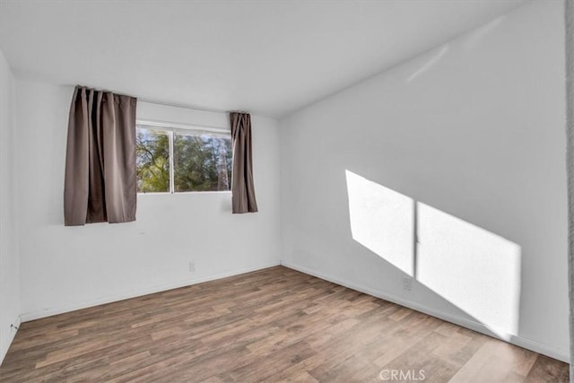 empty room with hardwood / wood-style flooring