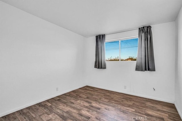 spare room with dark hardwood / wood-style floors