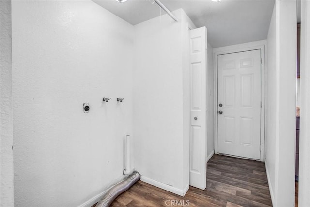 laundry room featuring electric dryer hookup and dark hardwood / wood-style flooring