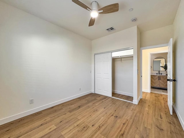 unfurnished bedroom with ceiling fan, a closet, and light hardwood / wood-style floors