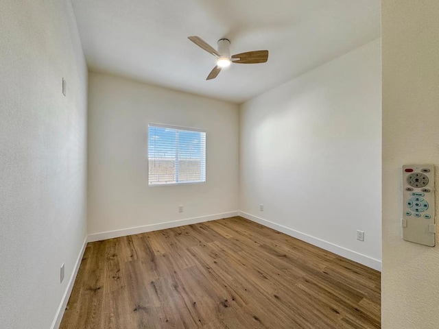 spare room with hardwood / wood-style flooring and ceiling fan