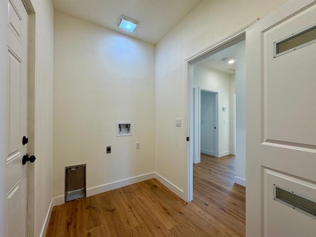 clothes washing area with washer hookup, electric dryer hookup, and light hardwood / wood-style flooring