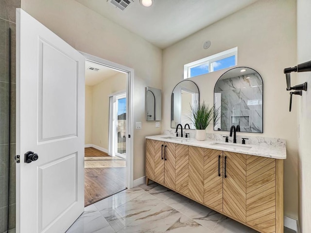 bathroom with a shower, vanity, and hardwood / wood-style flooring