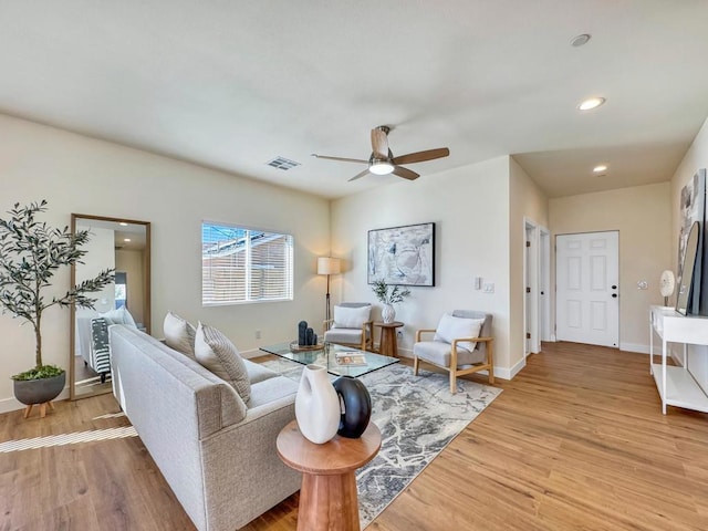 living room with ceiling fan and wood-type flooring