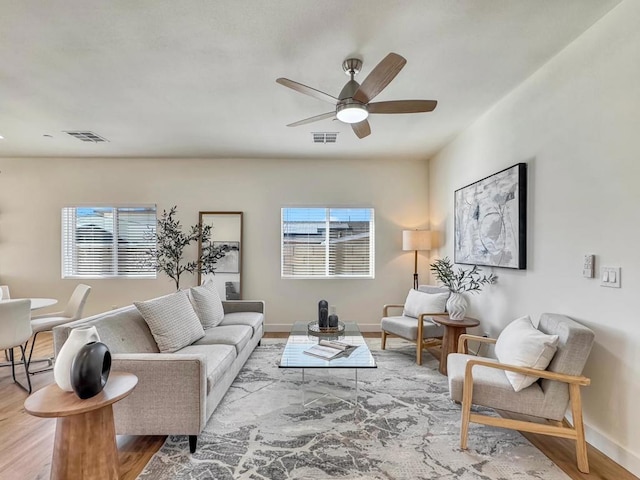 living room with ceiling fan and light wood-type flooring