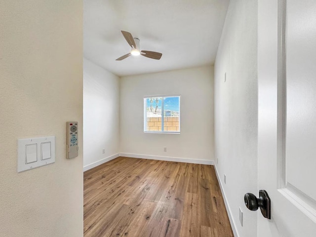 empty room featuring ceiling fan and light wood-type flooring