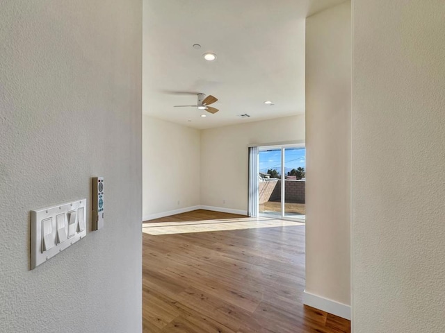 spare room with ceiling fan and hardwood / wood-style flooring