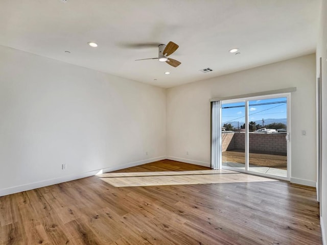 spare room featuring ceiling fan and light hardwood / wood-style flooring