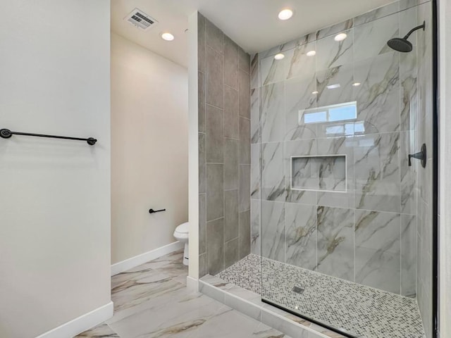 bathroom with toilet and a tile shower