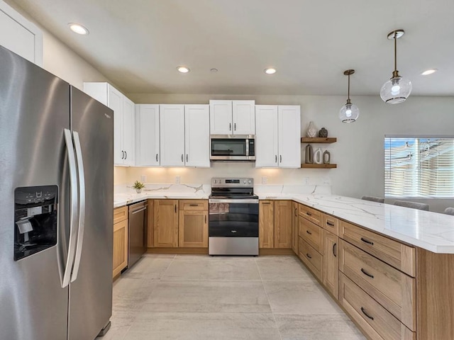 kitchen featuring pendant lighting, kitchen peninsula, light tile patterned flooring, white cabinetry, and stainless steel appliances