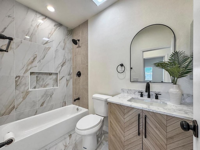 full bathroom featuring vanity, a skylight, toilet, and tiled shower / bath