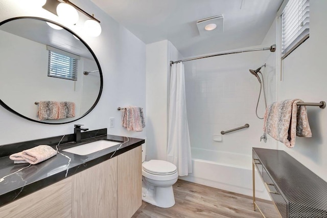 full bathroom with hardwood / wood-style flooring, shower / bath combination with curtain, toilet, and vanity