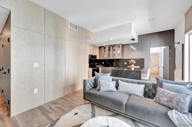 living room featuring sink and light wood-type flooring