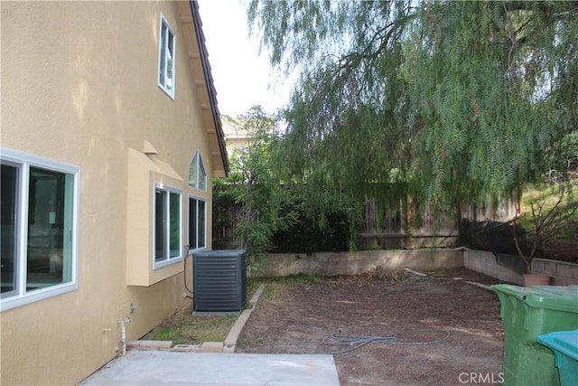 view of yard featuring central AC unit, a patio area, and a fenced backyard