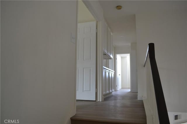 corridor featuring dark wood-style floors and visible vents