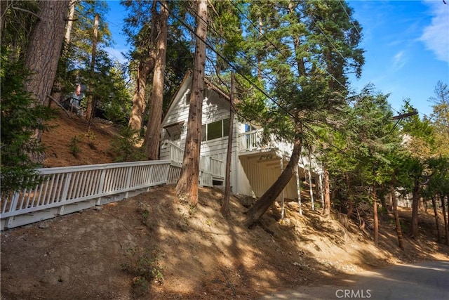 view of side of property featuring a wooden deck