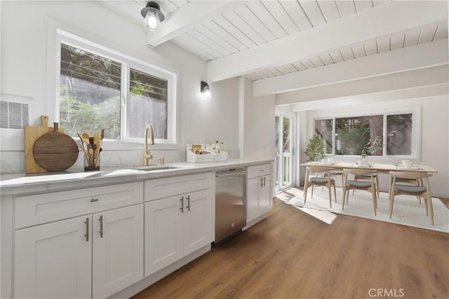 kitchen featuring dishwasher, white cabinets, sink, dark hardwood / wood-style floors, and beam ceiling