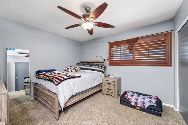 bedroom with ceiling fan and light colored carpet