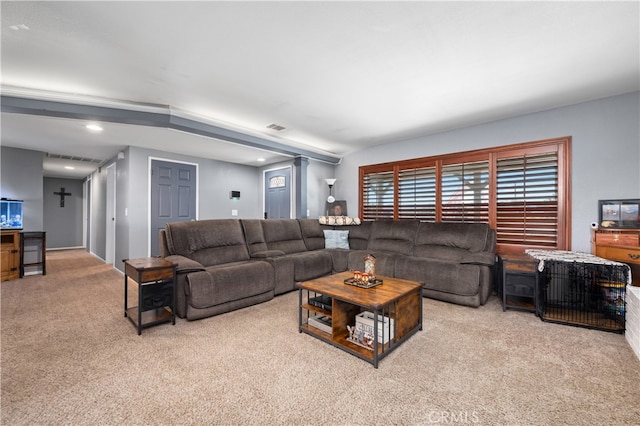 living room with light colored carpet, a wealth of natural light, and decorative columns