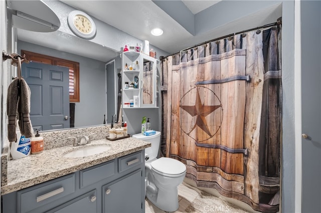 bathroom featuring vanity and toilet