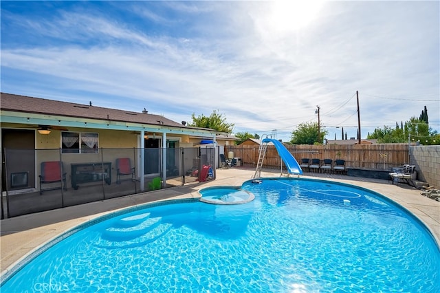 view of pool featuring a patio and a water slide