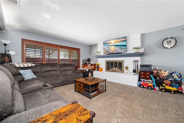 living room with carpet and a brick fireplace