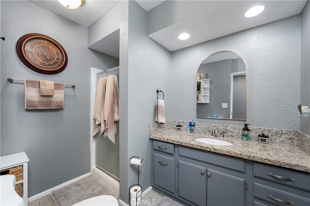 bathroom with vanity and a shower with shower door