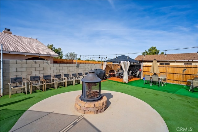 view of patio / terrace featuring a grill and a fire pit