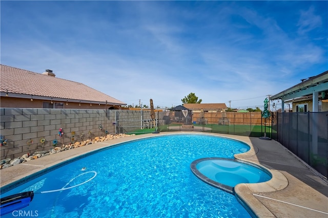 view of pool with an in ground hot tub