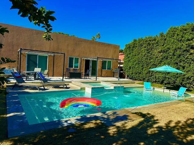 view of swimming pool featuring an in ground hot tub and a patio