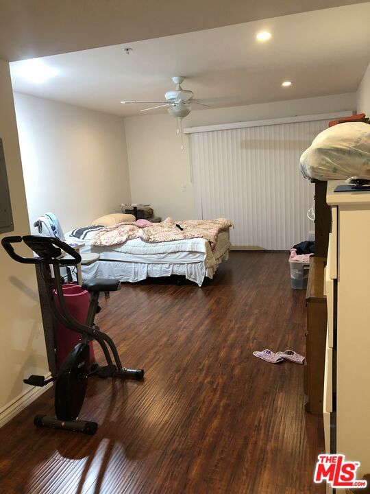 bedroom with ceiling fan and dark wood-type flooring