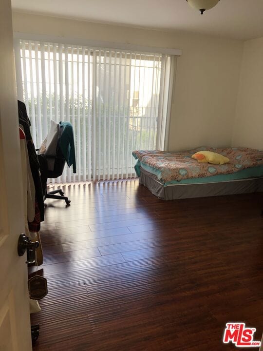 bedroom featuring access to outside and dark hardwood / wood-style flooring