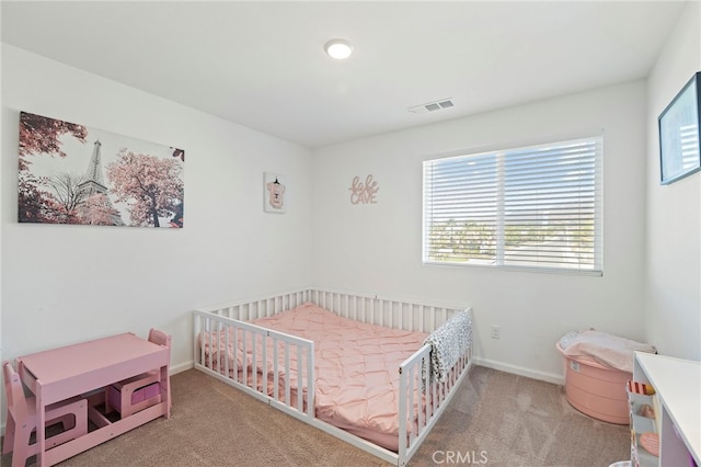 bedroom featuring light colored carpet and a crib