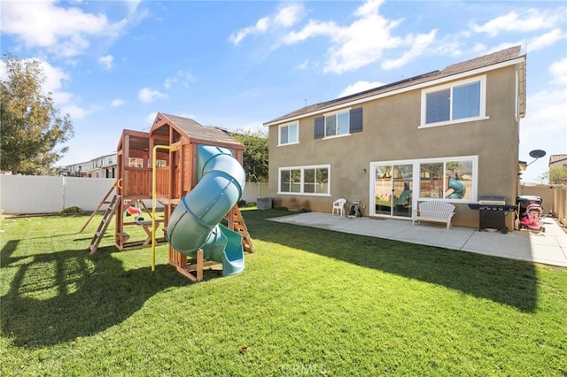 back of property with central air condition unit, a patio area, a yard, and a playground