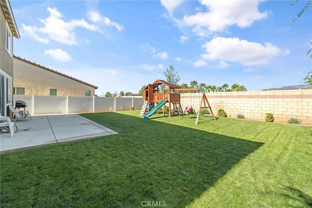 view of yard featuring a playground and a patio area