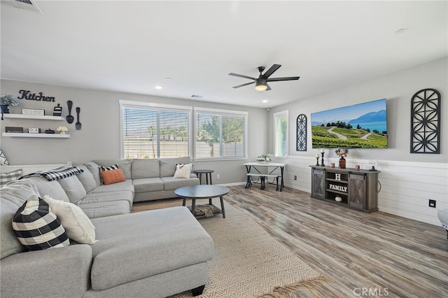 living room featuring ceiling fan and hardwood / wood-style floors