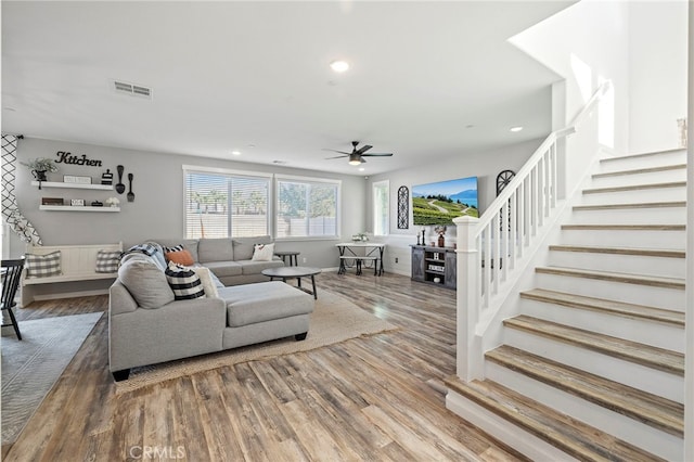 living room with ceiling fan and hardwood / wood-style flooring