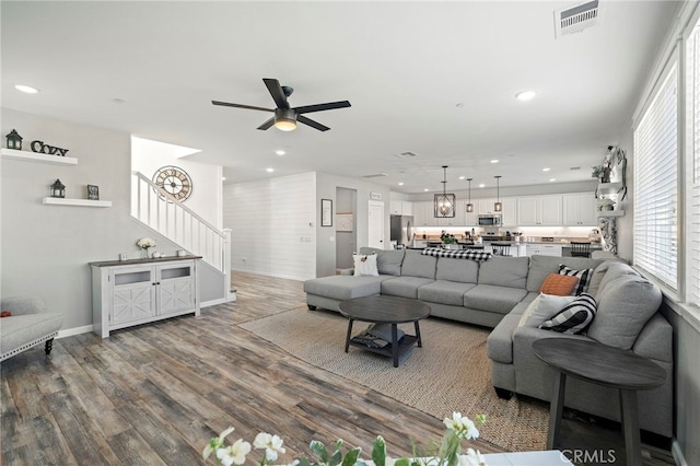 living room with ceiling fan and hardwood / wood-style floors