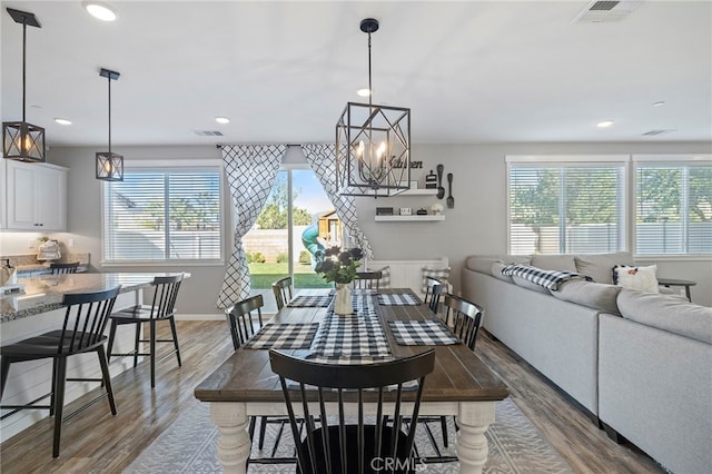 dining room featuring wood-type flooring and a chandelier