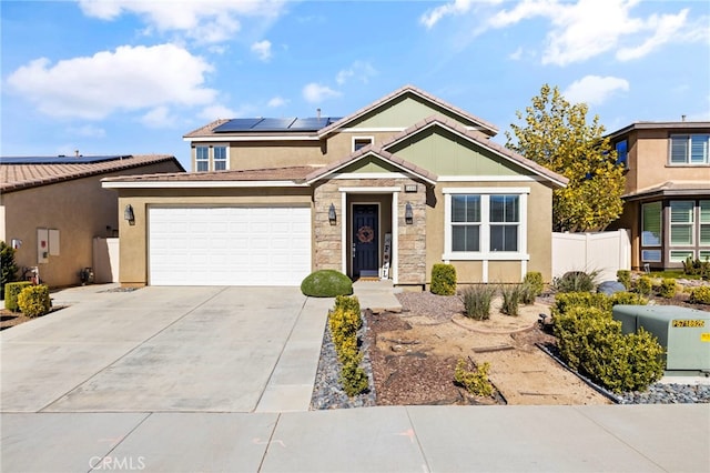 view of front of house featuring a garage and solar panels