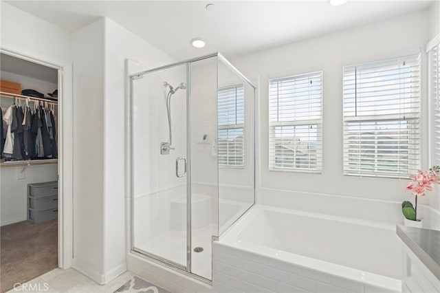 bathroom with tile patterned floors and shower with separate bathtub