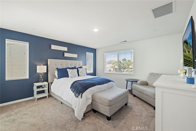 bedroom featuring light carpet