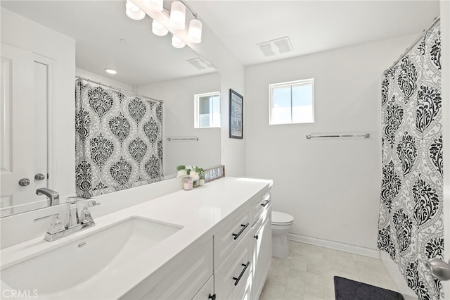 bathroom featuring toilet and vanity