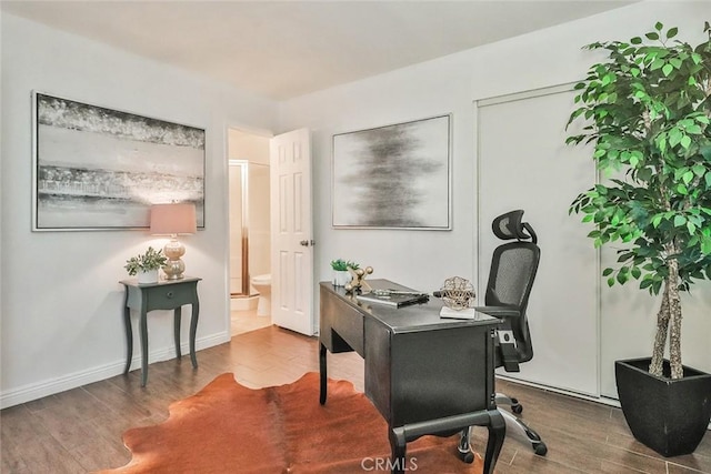 home office with hardwood / wood-style flooring