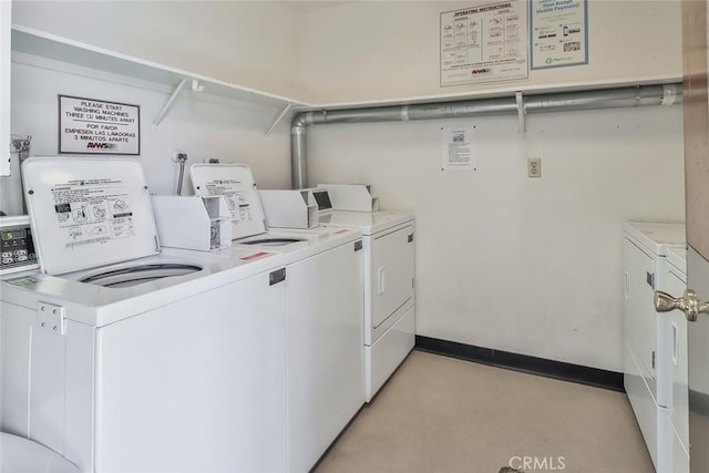 clothes washing area with independent washer and dryer