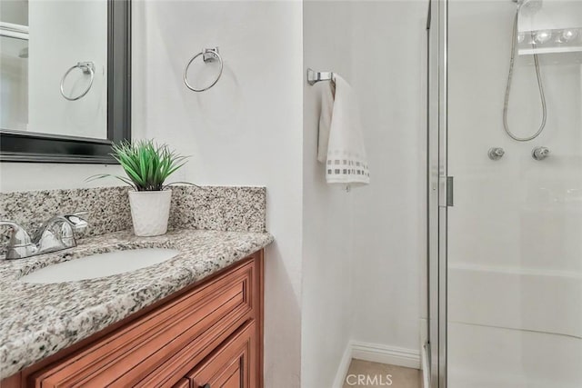 bathroom featuring vanity and a shower with door