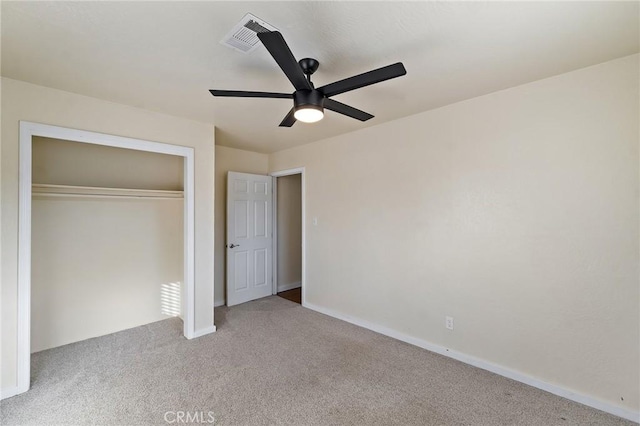 unfurnished bedroom with light carpet, a closet, and ceiling fan