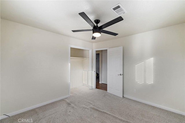 unfurnished bedroom with ceiling fan, light colored carpet, and a closet